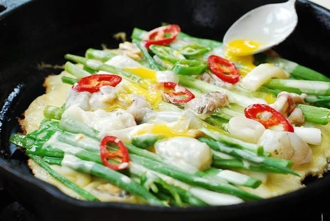 Traditional Korean Haemul Pajeon made with seafood and green onions
