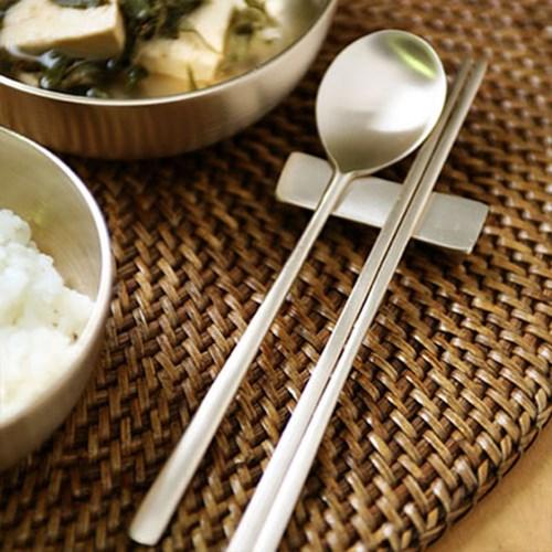 Korean spoon and chopsticks with a traditional meal